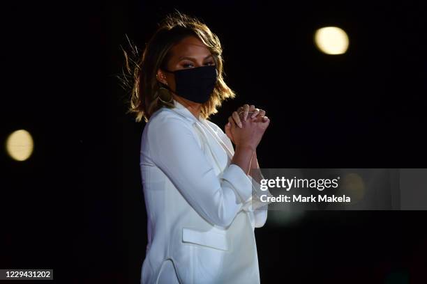 Model Chrissy Teigen, wife of singer John Legend, waits before taking the stage before Democratic vice presidential nominee Sen. Kamala Harris speaks...