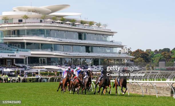 The field passes the winning post for the first time in the Lexus Melbourne Cup at Flemington Racecourse on November 03, 2020 in Flemington,...