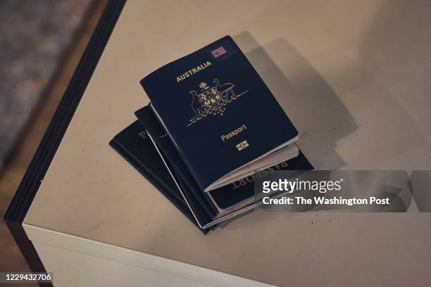 Michelle Reeves and Marc Reeves and their familys passports to Australia seen on the counterspace on July 27, 2020. Due to Covid-19, many families...