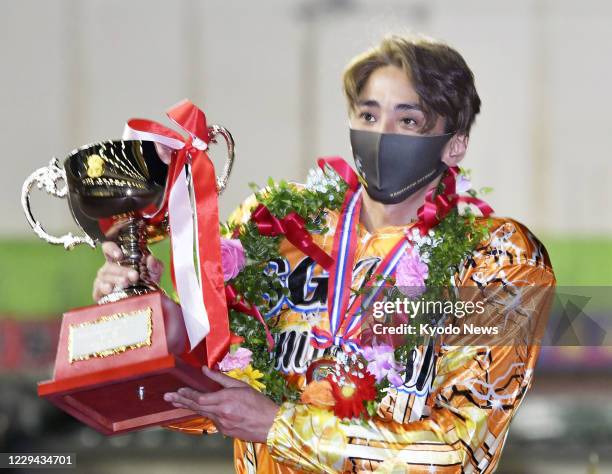Katsuyuki Mori, a former member of now-disbanded pop group SMAP, celebrates after winning the national championship in auto race, a Japanese version...