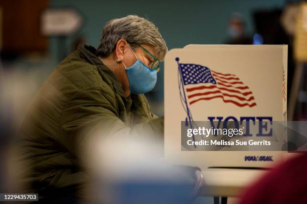 Barb Lambert fills out a ballot in the General Election with in the first half hour of voting on November 3, 2020 in Fayetteville, United States....