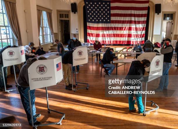 Voters cast their ballots at the old Stone School, used as a polling station, on election day in Hillsboro, Virginia on November 3, 2020. Polling...