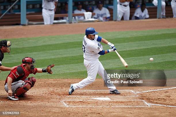 Dioner Navarro of the Los Angeles Dodgers takes a swing at a pitch while catcher Miguel Montero the Arizona Diamondbacks catches during the game on...