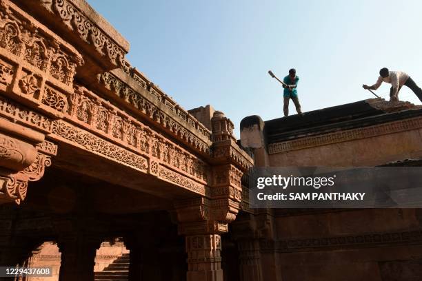 Workers are seen during the renovation process of the ancient 'Adalaj-Ni-Vav' stepwell in Adalaj in Gandhinagar on November 3, 2020.