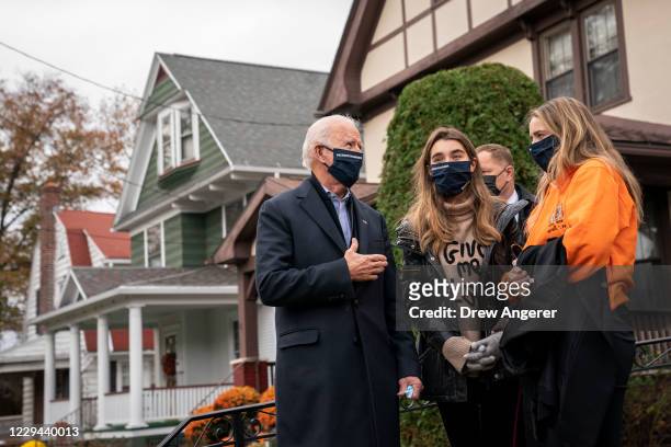 Democratic presidential nominee Joe Biden talks with his grandchildren Natalie Biden and Finnegan Biden outside of his childhood home on November 03,...