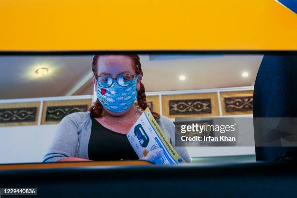 Briseida Guerra works on her choices on a Ballot Marking Device at a polling station located in a mosque Masjid Al-Fatiha on Tuesday, Nov. 3, 2020 in...