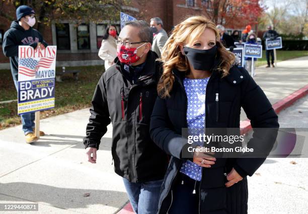 Cranston Mayor Allan W. Fung, left, and his wife Barbara Ann Fenton-Fung walk in to cast their ballots at the Hope Highlands Middle School polling...