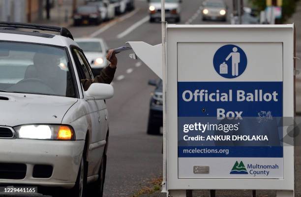 Oregon residents drop off their ballots near the Multnomah County Elections building in Portland, Oregon, on November 3, 2020. Americans were voting...