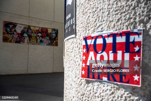Vote Here" sign is taped to a wall near a polling location on election day on November 3, 2020 in Austin, Texas. The United States started voting...
