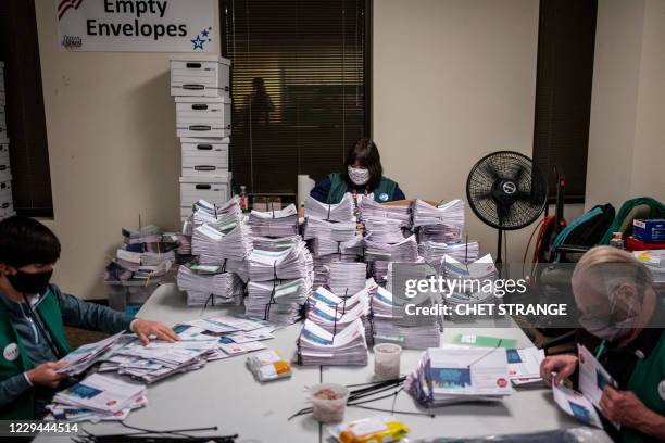 Election judges verify and count ballots at the Denver Elections Division building on November 3, 2020 in Denver, Colorado. The United States started...