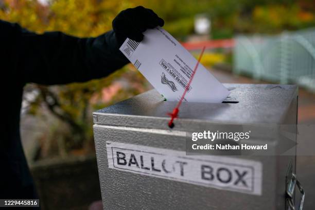 An election worker places a returned ballot in a dropbox on November 3, 2020 in Vancouver, Washington. After a record-breaking early voting turnout,...