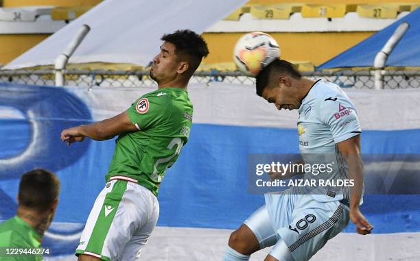 Bolivia's Bolivar Diego Bejarano and Chile's Audax Italiano Nicolas Orellana vie for the ball during their closed-door Copa Sudamericana second round...