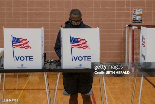 Resident casts his vote on November 3 at Eisenhower Elementary School in Flint, Michigan. The US is voting Tuesday in an election amounting to a...