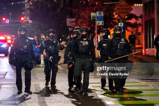 Police follow protesters as they move through the city during racial justice protests on November 3, 2020 in Seattle, Washington. Police say they...