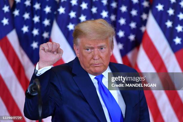 President Donald Trump pumps his fist after speaking during election night in the East Room of the White House in Washington, DC, early on November...