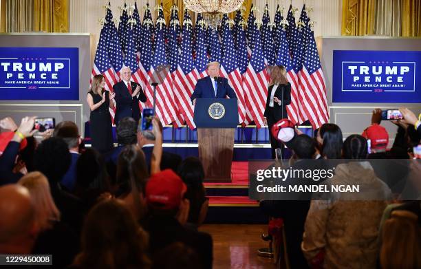 President Donald Trump, flanked by Karen Pence , US Vice President Mike Pence and US First Lady Melania Trump , speaks during election night in the...