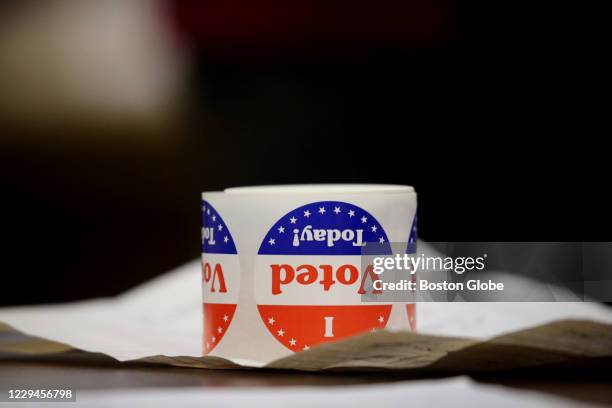 Stickers sit on a table at Saint John the Baptist Parish in Quincy, MA on election day, November 03, 2020. Massachusetts voters headed to the polls...