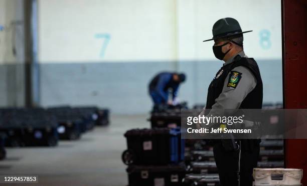 Election precinct suitcases containing ballots, election materials and keys to voting machines are held under guard by the Allegheny County Police at...
