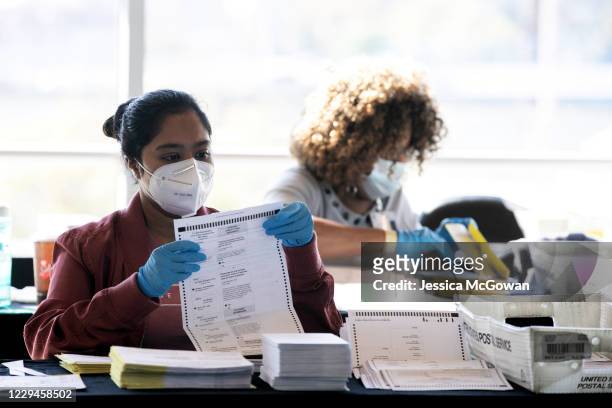 Election workers count Fulton County ballots at State Farm Arena on November 4, 2020 in Atlanta, Georgia. The 2020 presidential race between...