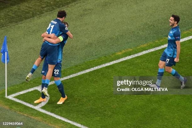 Zenit St. Petersburg's Russian midfielder Aleksandr Erokhin celebrates with teammates after scoring the opening goal during the UEFA Champions League...