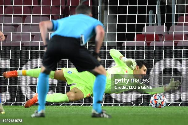 Dynamo Kiev's Ukrainian goalkeeper Ruslan Neshcheret dives for the ball during the UEFA Champions League group G football match between Barcelona and...