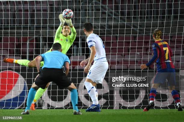 Dynamo Kiev's Ukrainian goalkeeper Ruslan Neshcheret makes a save during the UEFA Champions League group G football match between Barcelona and...