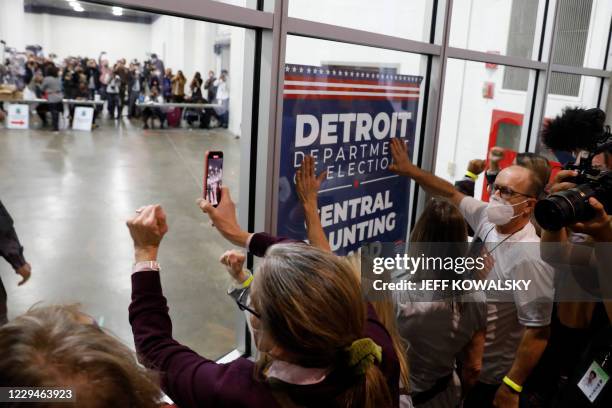 Supporters of US President Donald Trump bang on the glass and chant slogans outside the room where absentee ballots for the 2020 general election are...