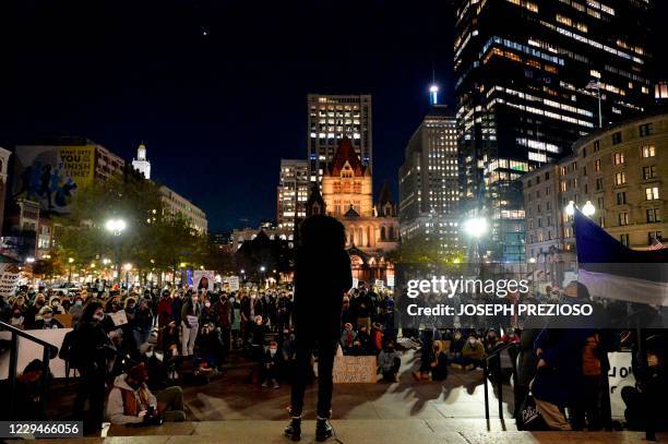 An activist addresses hundreds of people gathered at Copley Square at the Boston Public Library calling for revolution, socialism and civil...