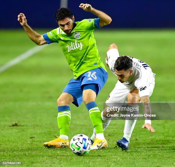 Alex Roldan of Seattle Sounders and Cristian Pavon of Los Angeles Galaxy battle for the ball in the first half of the game at Dignity Health Sports...