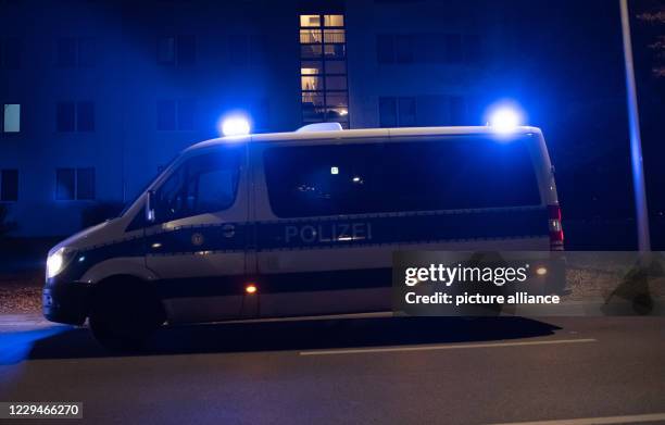 November 2020, Berlin: A police emergency vehicle is parked in front of an apartment building in the Plänterwald district . A three-year-old girl has...