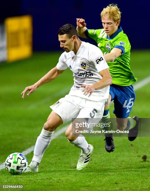 Daniel Steres of Los Angeles Galaxy and Ethan Dobbelaere of Seattle Sounders battle for the ball in the first half of the game at Dignity Health...