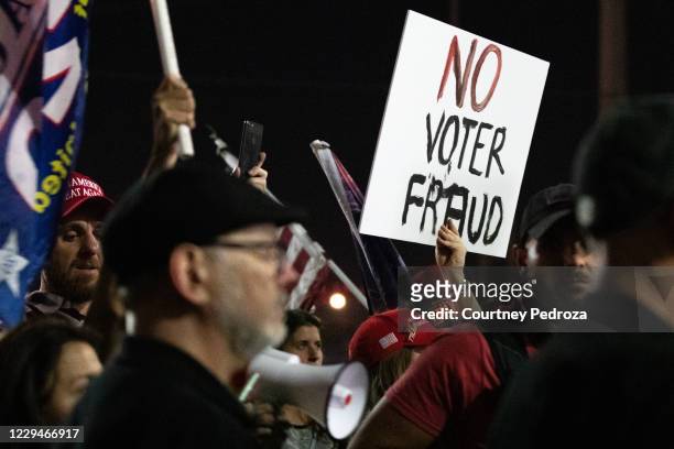 No voter fraud sign is displayed by a protester in support of President Donald Trump at the Maricopa County Elections Department office on November...