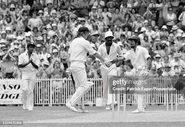 Gary Cosier of Australia, batting in his debut Test, is congratulated on reaching his maiden Test century by West Indies wicketkeeper Deryck Murray...