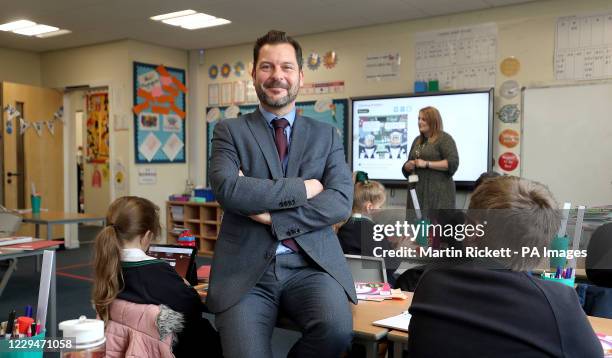 Simon Cotterill, Head Teacher of Manor Park School and Nursery in Knutsford, Cheshire, sits in a classroom as year 4 pupils take part in a maths...