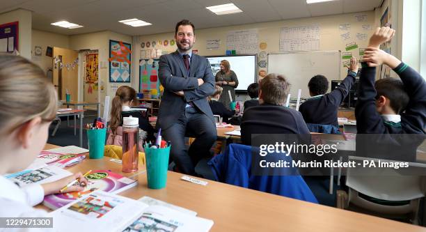 Simon Cotterill, Head Teacher of Manor Park School and Nursery in Knutsford, Cheshire, sits in a classroom as year 4 pupils take part in a maths...