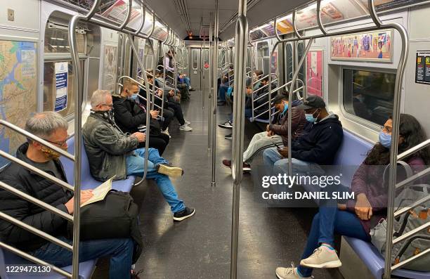 Commuters ride the New York City Subway on November 5 as the coronavirus pandemic continues worldwide.