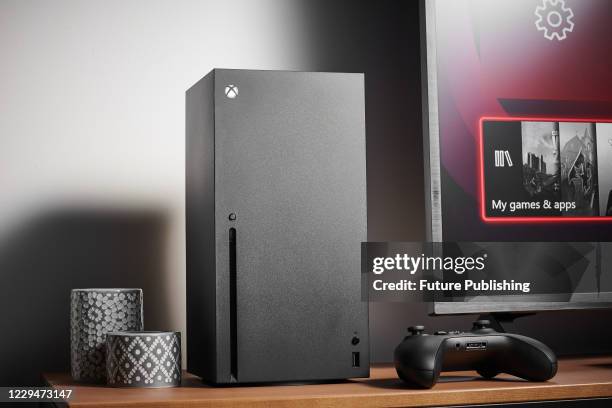 Living room with a Microsoft Xbox Series X home video game console alongside a television and soundbar, taken on October 9, 2020.