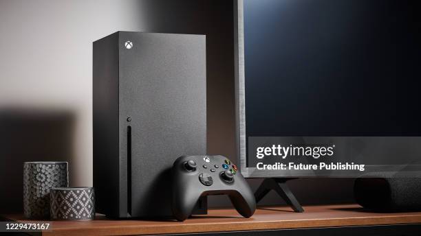 Living room with a Microsoft Xbox Series X home video game console alongside a television and soundbar, taken on October 9, 2020.
