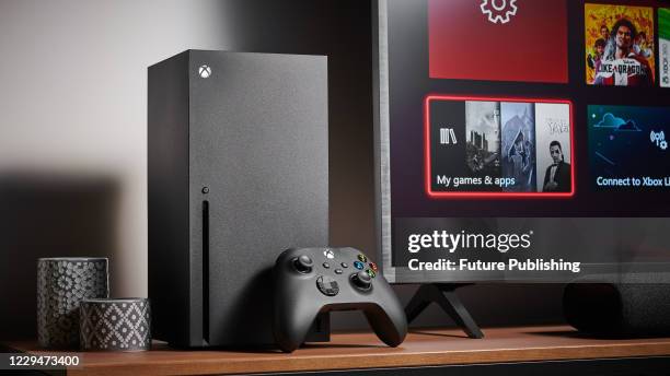 Living room with a Microsoft Xbox Series X home video game console alongside a television and soundbar, taken on October 9, 2020.