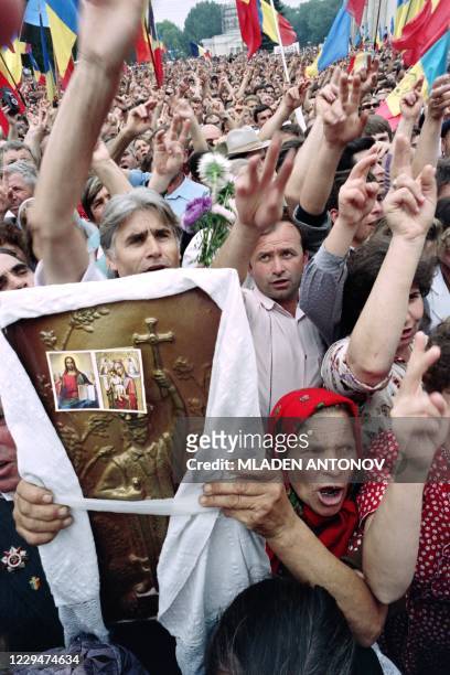 Moldavians flash the V-sign during a demonstration staged in central square after the parliament declared its independence on August 27, 1991 in...