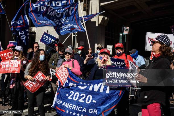 Supporters of U.S. President Donald Trump holds signs and flags while rallying in front of the Convention Center during the 2020 Presidential...