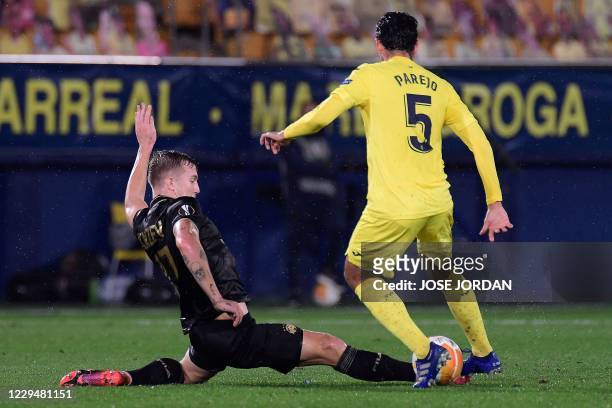 Maccabi Tel Aviv's Israeli midfielder Eden Karzev challenges Villarreal's Spanish midfielder Daniel Parejo during the UEFA Europa League group I...