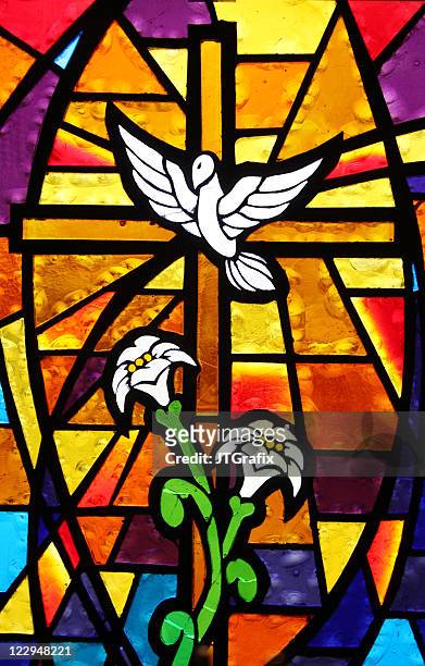 multicolored stained glass window - cross with dove and lilies - spirituality stock pictures, royalty-free photos & images