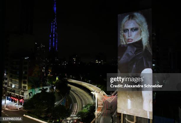 An image of Brazilian model Raquel Zimmermann is projected onto a building in celebration of 25 years of Sao Paulo Fashion Week on November 5, 2020...