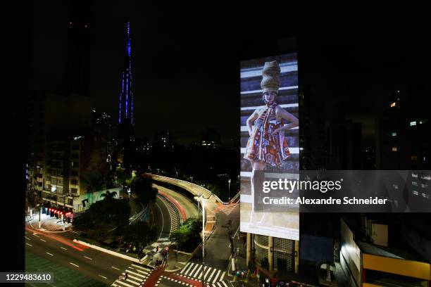 An image of Brazilian model Carol Ribeiro is projected onto a building in celebration of 25 years of Sao Paulo Fashion Week on November 5, 2020 in...