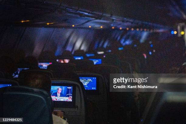 Passenger watches a CNN broadcast of President Donald Trump speaking from the White House aboard a Delta flight bound for Hartsfield-Jackson Atlanta...