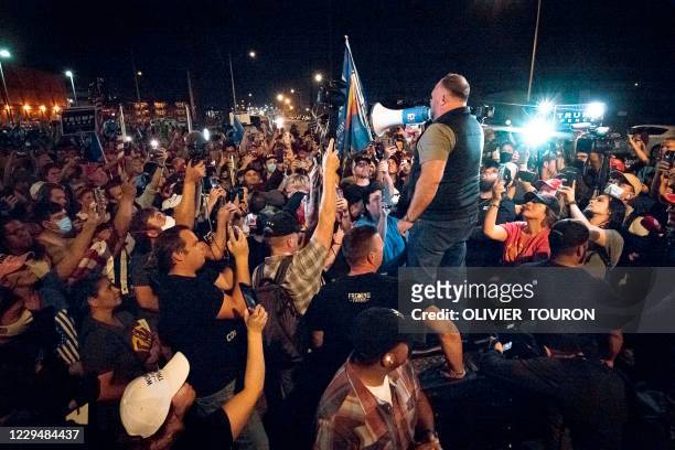 Radio host and conspiracy theorist Alex Jones shouts "America is Awake" as he speaks to Trump supporters gathered in front of the Maricopa County...