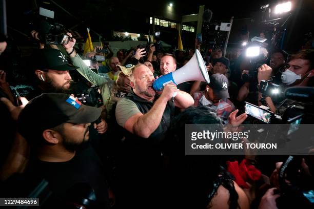 Radio host and conspiracy theorist Alex Jones shouts "America is Awake" and speaks to Trump supporters gathered in front of the Maricopa County...