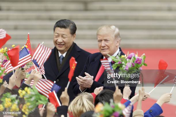 Bloomberg Best Of U.S. President Donald Trump 2017 U.S. President Donald Trump, right, and Xi Jinping, China's president, greet attendees waving...