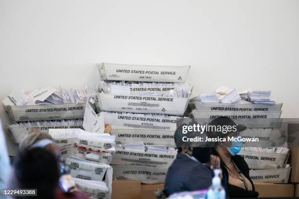 Security envelopes for absentee ballots sit in stacked boxes as Fulton county workers continue to count absentee ballots at State Farm Arena on...